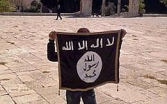 A youngster holding an IS flag on the Temple Mount in Jerusalem (photo credit: Facebook)