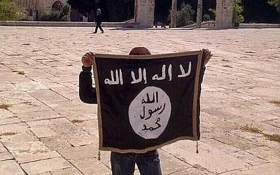 A youngster holding an IS flag on the Temple Mount in Jerusalem (photo credit: Facebook)