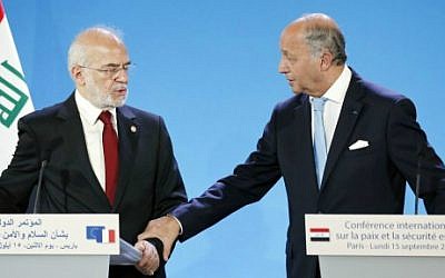 French Foreign Affairs Minister Laurent Fabius and his Iraq's counterpart Ibrahim al-Jaafari give a press conference as part of the International Conference on Peace and Security in Iraq in Paris on September 15, 2014. (photo credit: Thomas Samson/AFP)