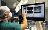 A back surgeon looks at a 3D model of a patient's spinal column in preparation for surgery using the Mazor Renaissance system. (Courtesy)
