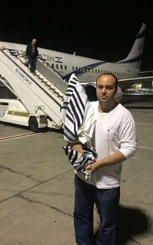 From the Depths head Jonny Daniels brings the ruined Torah scroll back to Israel for repair by Holocaust survivors. (courtesy)
