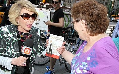 Joan Rivers talks with people on the street while promoting her new book ‘Diary of a Mad Diva’ on June 30, 2014 in New York City. (Photo credit: Rob Kim/Getty Images)