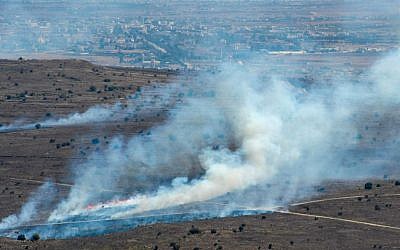 Smoke rises near Quneitra Crossing as it seen from the Golan Heights in the Israeli side on August 27, 2014 (photo credit: Flash90)
