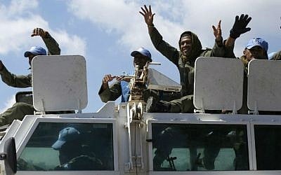 UN Fijian peacekeepers members of the United Nations Disengagement Observer Force (UNDOF) wave as they ride on top of a vehicle while leaving the Syrian side of the Golan Heights into the Israeli side of the strategic plateau, on September 15, 2014 (photo credit: AFP/ JALAA MAREY)