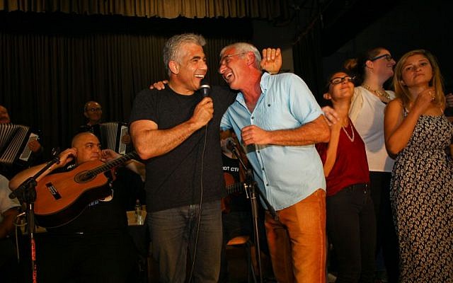 Yair Lapid, left, at a community singalong in southern Israel on Friday, September 12, 2014. (photo credit: Courtesy) Yair Lapid, left, at a community singalong in southern Israel on Friday, September 12, 2014. (photo credit: Courtesy)