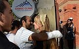 Eitan Idan, an Israeli Himalayan snowstorm survivors,  talks to compatriots after his discharge from a hospital before heading to the airport in Kathmandu on October 18, 2014. (photo credit: AFP/Prakash MATHEMA)