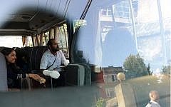 Eitan Idan, an Israeli Himalayan snowstorm survivor (second from the left), is treated for frostbite, looks on from a chartered bus as he is discharged from a hospital before heading to the airport in Kathmandu on October 18, 2014. (photo credit: AFP/Prakash MATHEMA)