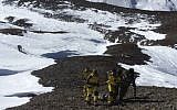Members of the Nepalese Army pulling dead bodies of trekkers from the Thorung La mountain pass on the Annapurna Circuit, in Manang District, Nepal, October 16, 2014. (photo credit: (AFP/HO/Nepalese Army)