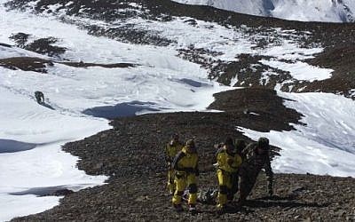 Members of the Nepalese Army pulling dead bodies of trekkers from the Thorung La mountain pass on the Annapurna Circuit, in Manang District, Nepal, October 16, 2014. (photo credit: (AFP/HO/Nepalese Army)