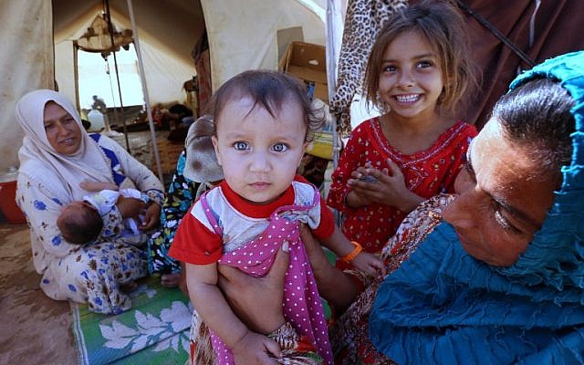 Iraqi refugees displaced by the Islamic State jihadist group, at the Ayden camp, an extension of the larger Aliama camp, in the town of Khanaqin, northeast of Baghdad, on September 27, 2014 (photo credit: AFP/Safin Hamed) Iraqi refugees displaced by the Islamic State jihadist group, at the Ayden camp, an extension of the larger Aliama camp, in the town of Khanaqin, northeast of Baghdad, on September 27, 2014 (photo credit: AFP/Safin Hamed)
