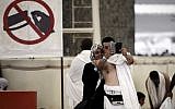 Muslim pilgrims pose for a selfie during the "Jamarat" ritual, the stoning of Satan, in Mina near the holy city of Mecca, on October 4, 2014. (photo credit: AFP/Mohammed al-Shaikh)