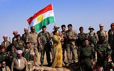 Turkish Kurdish singer Gulistan Perwer (C) performs for Kurdish Peshmerga fighters on the front line during the Muslim holiday of Eid al-Adha in the Gwer district, 40 kilometres south of Arbil, the capital of the Kurdish autonomous region in northern Iraq, on October 5, 2014. (photo credit: AFP Photo/Safin Hamed)