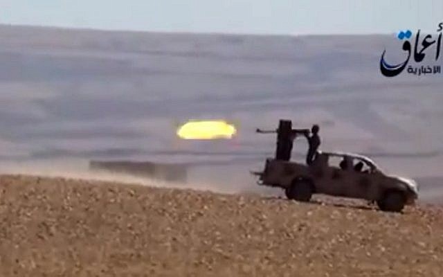Illustrative screen capture from a YouTube video allegedly shows Islamic State group fighters firing from an armed vehicle (AFP/HO/AAMAQ NEWS AGENCY) Illustrative screen capture from a YouTube video allegedly shows Islamic State group fighters firing from an armed vehicle (AFP/HO/AAMAQ NEWS AGENCY)