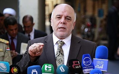 Iraqi Prime Minister Haider al-Abadi gives a press conference in the Iraqi central shrine city of Najaf, October 20, 2014 (AFP/Haider Hamdani)