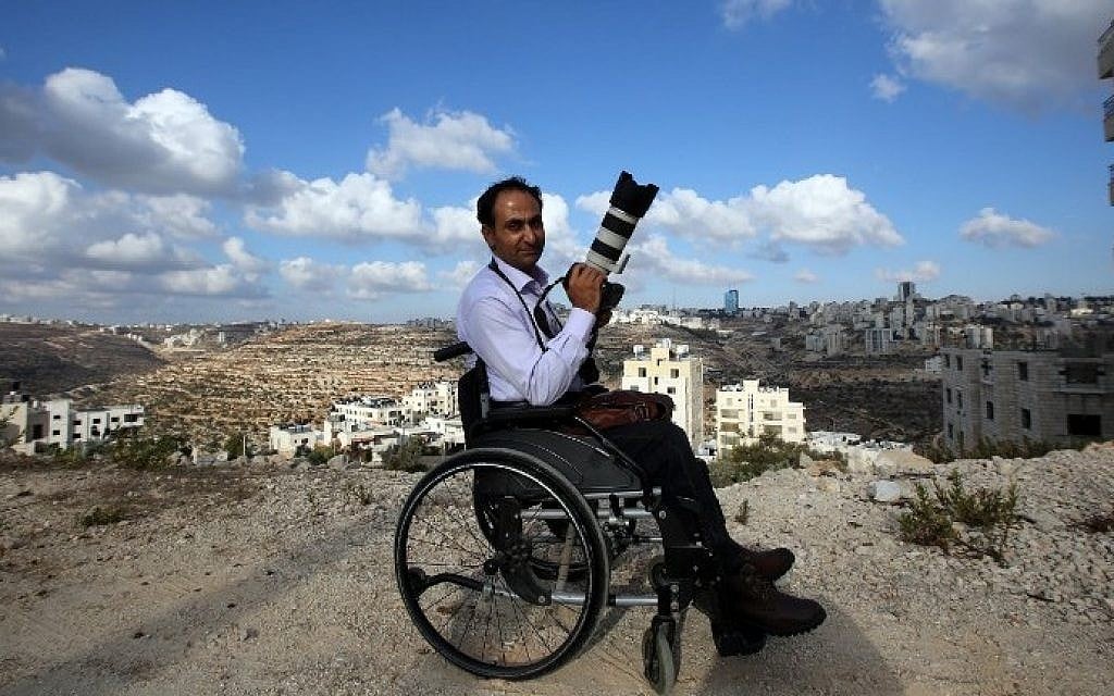 Palestinian photographer Osama Silwadi poses for a picture in the West Bank city of Ramallah on September 10, 2014. (photo credit: Abbas Momani/AFP) Palestinian photographer Osama Silwadi poses for a picture in the West Bank city of Ramallah on September 10, 2014. (photo credit: Abbas Momani/AFP)