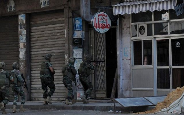 Lebanese soldiers raid an apartment in Lebanon's northern port city of Tripoli, where two men suspected of spying on Lebanese military bases are believed to be on October 26, 2014. (Photo credit: AFP PHOTO / IBRAHIM CHALHOUB) Lebanese soldiers raid an apartment in Lebanon's northern port city of Tripoli, where two men suspected of spying on Lebanese military bases are believed to be on October 26, 2014. (Photo credit: AFP PHOTO / IBRAHIM CHALHOUB)