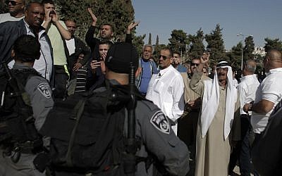 A group of Palestinian men protest near Jerusalem's Dome of the Rock on October 27, 2014. (PHOTO CREDIT: AFP/ AHMAD GHARABLI)