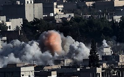 Smoke rises after strikes from the US-led coalition in the Syrian town of Kobani, on October 10, 2014 (Photo credit: Aris Messinis/AFP)