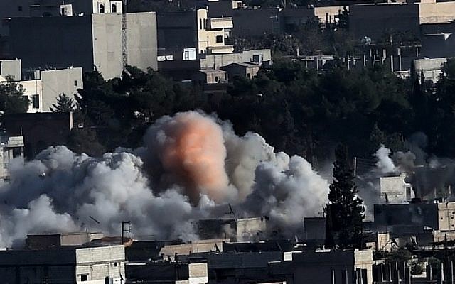Smoke rises after strikes from the US-led coalition in the Syrian town of Kobani, on October 10, 2014 (Photo credit: Aris Messinis/AFP) Smoke rises after strikes from the US-led coalition in the Syrian town of Kobani, on October 10, 2014 (Photo credit: Aris Messinis/AFP)
