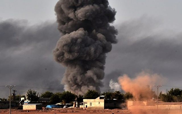 Smoke rises from the the Syrian town of Ayn al-Arab, known as Kobani by the Kurds, after a strike from the US-led coalition as it seen from the Turkish - Syrian border in the southeastern village of Mursitpinar, Sanliurfa province, on October 13, 2014. (Photo credit: AFP/ARIS MESSINIS) Smoke rises from the the Syrian town of Ayn al-Arab, known as Kobani by the Kurds, after a strike from the US-led coalition as it seen from the Turkish - Syrian border in the southeastern village of Mursitpinar, Sanliurfa province, on October 13, 2014. (Photo credit: AFP/ARIS MESSINIS)