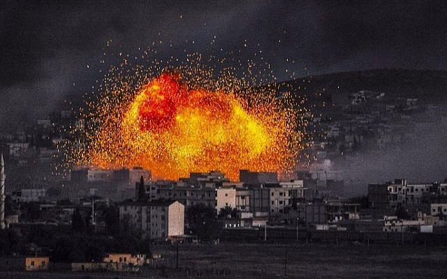 Smoke and flames rise following an explosion in the Syrian town of Kobane on October 20, 2014. (photo credit: AFP/BULENT KILIC)