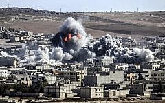 Smoke and flames billow following an explosion in the Syrian town of Kobani, October 22, 2014.  (photo credit: AFP/STRINGER)