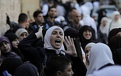A Palestinian woman shouts after being blocked by Israel security forces from entering the Al-Aqsa Mosque compound, Islam's third most holy site in Jerusalem on October 13, 2014. (photo credit: AFP/Ahmad Gharabli)