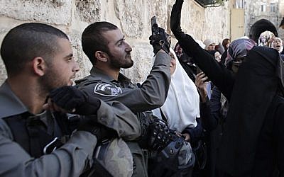 Palestinians blocked from entering the Al-Aqsa Mosque compound, Islam's third most holy site, clash with Israeli security forces during a protest against Jews entering the compound for the week-long Jewish holiday of Sukkot, or Feast of Tabernacles in Jerusalem on October 13, 2014. (photo credit: AFP/Ahmad Gharabli)