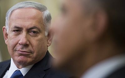 Prime Minister Benjamin Netanyahu looks on as US President Barack Obama speaks during a bilateral meeting at the White House in Washington, DC, October 1, 2014. (photo credit: AFP/Jim WATSON)