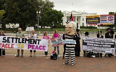 A protest against Israeli Prime Minister Benjamin Netanyahu's visit to the White House in Washington, DC, October 1, 2014. (photo credit: AFP/Jim WATSON)