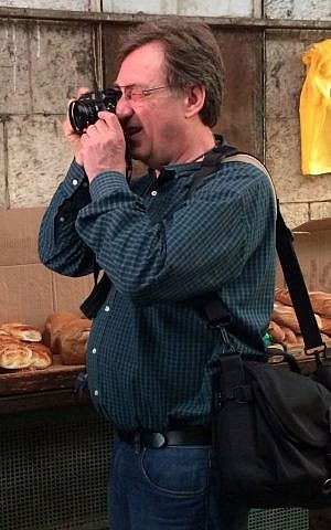 Paul Margolis shooting at Mahane Yehuda, Jerusalem. October 21, 2014. (photo credit: Renee Ghert-Zand)