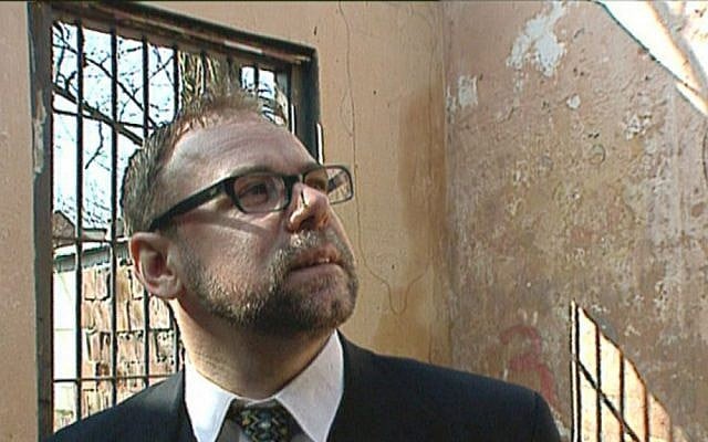 Warsaw Jewish community vice president Leszek Piszewski inspects derelict properties legally restored to the ownership of the Jewish community in "H-I-Jew Positive." (photo credit: Ron Katzenelson)