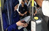 A Palestinian student reads her textbook on the light rail at Shuafat, Jerusalem, September 30, 2014 (photo credit: Elhanan Miller / Times of Israel)