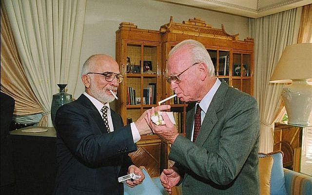 King Hussein lights Yitzhak Rabins cigarette following the signing ceremony, October 26, 1994 photo credit: GPO/Moshe Milner) King Hussein of Jordan lights Yitzhak Rabin's cigarette following the signing ceremony for the peace accord between Amman and Jerusalem, October 26, 1994. (GPO/Moshe Milner)