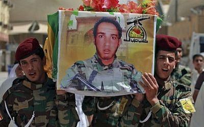 Iraqi Hezbollah fighters carry the coffin of a comrade killed in Mosul fighting Islamic militants, July 14, 2014 (Photo credit: Jaber al-Helo/AP)