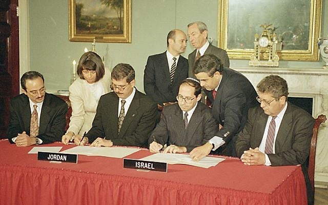 Fayez Tarawneh, Jordan's ambassador to the U.S., seated left, and Elyakim Rubinstein, head of the Israeli delegation to the Jordan-Israel peace talks, sign a preliminary agreement at the State Department in Washington D.C., September 14, 1993 photo credit: AP/Charles Tasnadi)