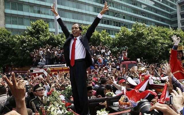 Indonesian President Joko Widodo gestures to the crowd during a street parade following his inauguration in Jakarta, Indonesia, Monday, Oct. 20, 2014. (photo credit: AP Photo/Achmad Ibraham) Indonesian President Joko Widodo gestures to the crowd during a street parade following his inauguration in Jakarta, Indonesia, Monday, Oct. 20, 2014. (photo credit: AP Photo/Achmad Ibraham)