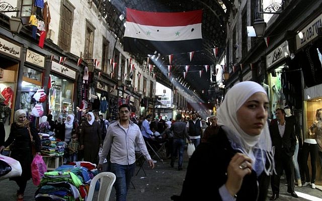 People shop in the ancient bazaar known as the Hamidiyeh souq in Damascus Syria, Monday, Oct. 27, 2014. (photo credit: AP/Diaa Hadid) People shop in the ancient bazaar known as the Hamidiyeh souq in Damascus Syria, Monday, Oct. 27, 2014. (photo credit: AP/Diaa Hadid)