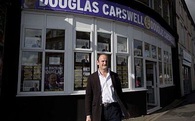 Douglas Carswell, the winning UK Independence Party (UKIP) candidate for the Clacton by-election, poses for photographs outside his campaign offices in Clacton-on-Sea, England, October 7, 2014. (photo credit: AP Photo/Matt Dunham) Douglas Carswell, the winning UK Independence Party (UKIP) candidate for the Clacton by-election, poses for photographs outside his campaign offices in Clacton-on-Sea, England, October 7, 2014. (photo credit: AP Photo/Matt Dunham)