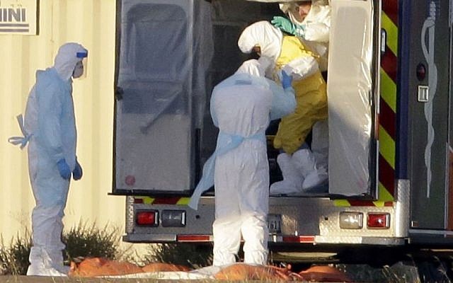 Medical staff in protective gear escort Nina Pham, exiting the ambulance, to a nearby aircraft at Love Field, Thursday, Oct. 16, 2014, in Dallas. Pham, a nurse at Texas Health Presbyterian Hospital Dallas, was diagnosed with the Ebola virus after caring for Thomas Eric Duncan who died of the same virus. (Photo credit: AP Photo/Tony Gutierrez) Medical staff in protective gear escort Nina Pham, exiting the ambulance, to a nearby aircraft at Love Field, Thursday, Oct. 16, 2014, in Dallas. Pham, a nurse at Texas Health Presbyterian Hospital Dallas, was diagnosed with the Ebola virus after caring for Thomas Eric Duncan who died of the same virus. (Photo credit: AP Photo/Tony Gutierrez)
