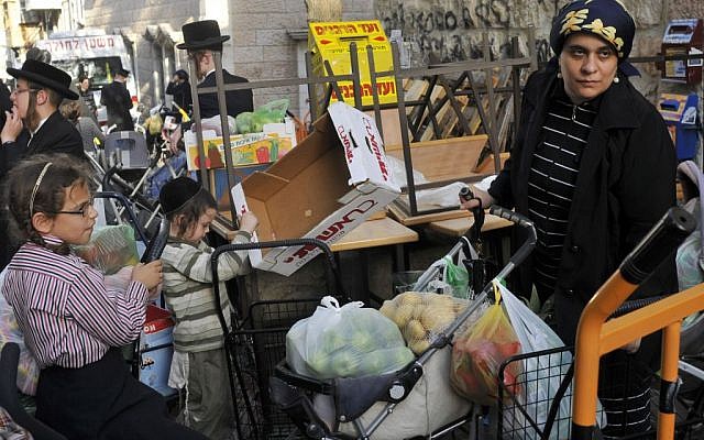 An ultra-Orthodox woman waits for food before the Sukkot holidays in the Mea Shearim market in Jerusalem. (photo credit: Serge Attal / Flash 90 An ultra-Orthodox woman waits for food before the Sukkot holidays in the Mea Shearim market in Jerusalem. (photo credit: Serge Attal / Flash 90