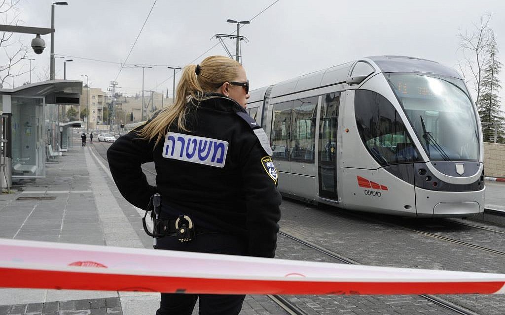 An Israeli police officer stands guard at the scene of a stabbing attack on the light rail in Pisgat Zeev in 2012. (photo credit: Uri Lenz/FLASH90) An Israeli police officer stands guard at the scene of a stabbing attack on the light rail in Pisgat Zeev in 2012. (photo credit: Uri Lenz/FLASH90)