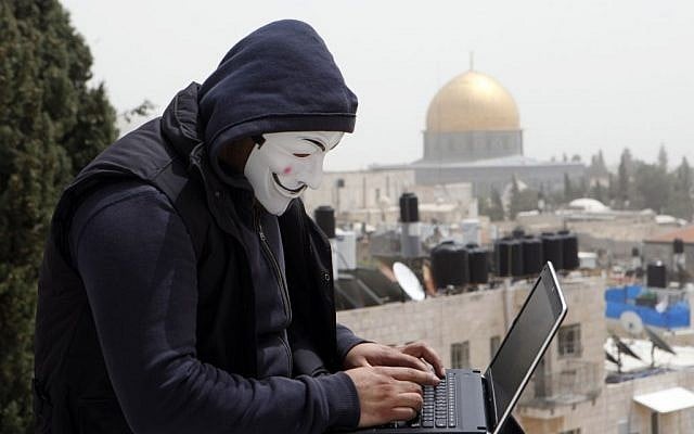 A Palestinian in a Guy Fawkes mask on a computer in Jerusalem, April 8, 2013. (photo credit: Sliman Khader/Flash90) A Palestinian in a Guy Fawkes mask on a computer in Jerusalem, April 8, 2013. (photo credit: Sliman Khader/Flash90)