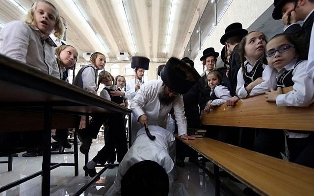An ultra-Orthodox man of the Hassidic Lelov dynasty whips another with a leather belt as a symbolic punishment for his sins during the traditional 'Malkot' ceremony, a few hours before the start of Yom Kippur, the Day of Atonement, in a synagogue in the town of Bet Shemesh, outside of Jerusalem. October 3, 2014. (Photo credit: Nati Shohat / FLASH90) An ultra-Orthodox man of the Hassidic Lelov dynasty whips another with a leather belt as a symbolic punishment for his sins during the traditional 'Malkot' ceremony, a few hours before the start of Yom Kippur, the Day of Atonement, in a synagogue in the town of Bet Shemesh, outside of Jerusalem. October 3, 2014. (Photo credit: Nati Shohat / FLASH90)