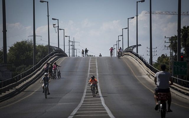 Israelis ride their bikes on empty streets during the holiday of Yom Kippur (photo credit: Hadas Parush/Flash 90)