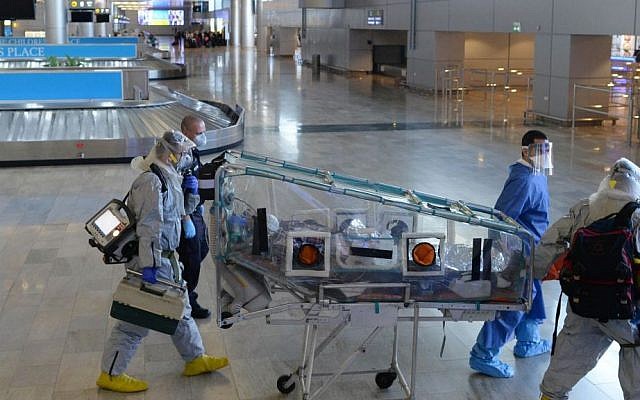 Israeli forces take part in a Ebola identification training exercise at Ben Gurion International Airport outside Tel Aviv on October 17, 2014, Officials and employees from the Population Immigration and Border Authority, airlines, the Magen David Adom emergency medical services, the Health Ministry and the police participated in the drill, aimed at identifying travelers who could potentially have contracted the virulent disease. (Photo credit: Kobi Gideon/GPO) Israeli forces take part in a Ebola identification training exercise at Ben Gurion International Airport outside Tel Aviv on October 17, 2014, Officials and employees from the Population Immigration and Border Authority, airlines, the Magen David Adom emergency medical services, the Health Ministry and the police participated in the drill, aimed at identifying travelers who could potentially have contracted the virulent disease. (Photo credit: Kobi Gideon/GPO)