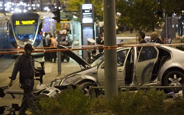 Police and rescue personnel are seen at the scene where several people were injured when a car crashed into the Jerusalem light rail station by Ammunition Hill, October 22, 2014. (photo credit: Yonatan Sindel/Flash90) Police and rescue personnel are seen at the scene where several people were injured when a car crashed into the Jerusalem light rail station by Ammunition Hill, October 22, 2014. (photo credit: Yonatan Sindel/Flash90)