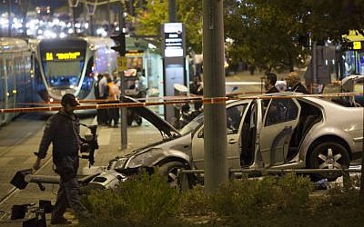 Police and rescue personnel at the scene where a baby was killed and several people were injured as a  Palestinian drove his car into the Jerusalem light rail station, by Ammunition Hill October 22, 2014. (Photo credit: Yonatan Sindel/Flash90)