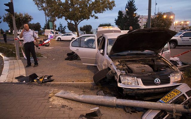 Police and rescue personnel at the scene where a Palestinian man drove a car into a Jerusalem Light Rail station, near Ammunition Hill, in a terror attack, October 22, 2014. (photo credit: Yonatan Sindel/Flash90) Police and rescue personnel at the scene where a Palestinian man drove a car into a Jerusalem Light Rail station, near Ammunition Hill, in a terror attack, October 22, 2014. (photo credit: Yonatan Sindel/Flash90)