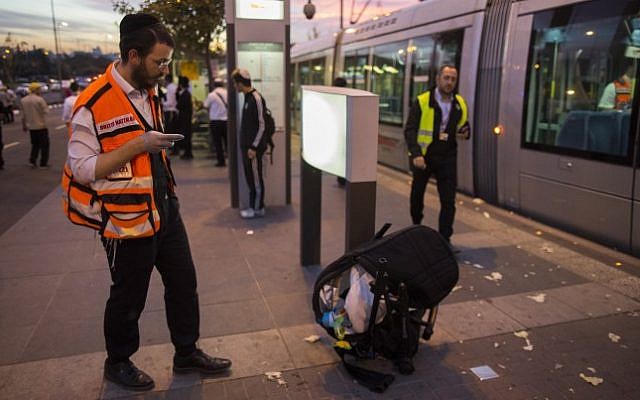 Police and rescue personnel at the scene where several people were injured after a Palestinian crashed a car into a Jerusalem light rail station, October 22, 2014. (photo credit: Yonatan Sindel/Flash90)